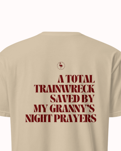 Back view of a Sand t-shirt featuring the phrase "A total trainwreck saved my granny's night prayers" on the back. Perfect for fans of funny merchandise, bold humor, and witty sarcasm.
