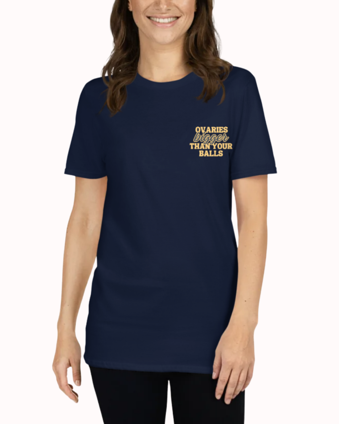 
Front view of a Navy t-shirt worn by a smiling woman, featuring the phrase "Ovaries bigger than your balls" on the chest and back. Perfect for fans of funny merchandise, bold humor, and witty sarcasm.
