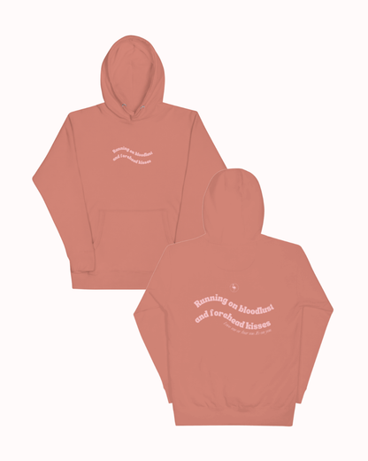 Front and back view of a Dusty Rose hoodie featuring the phrase "Running on bloodlust and forehead kisses" on the back. Perfect for fans of funny merchandise, bold humor, and witty sarcasm.