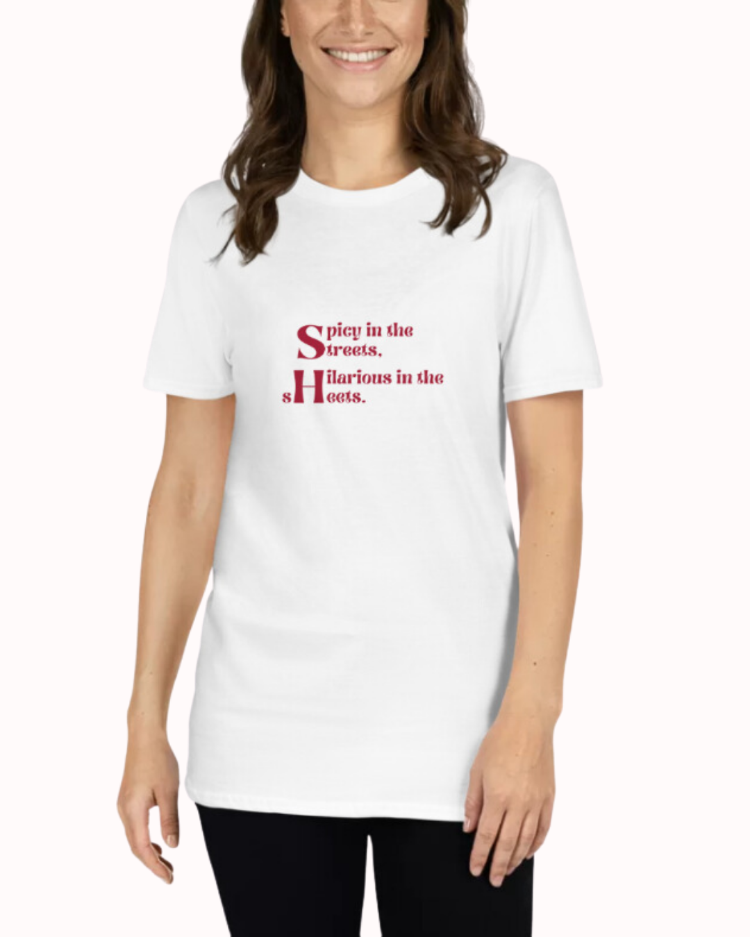 Front view of a white T-Shirt worn by a smiling woman, featuring the phrase 'Spicy in the streets, Hilarious in the sheets' on the chest. Perfect for fans of funny merchandise, bold humor, and witty sarcasm.