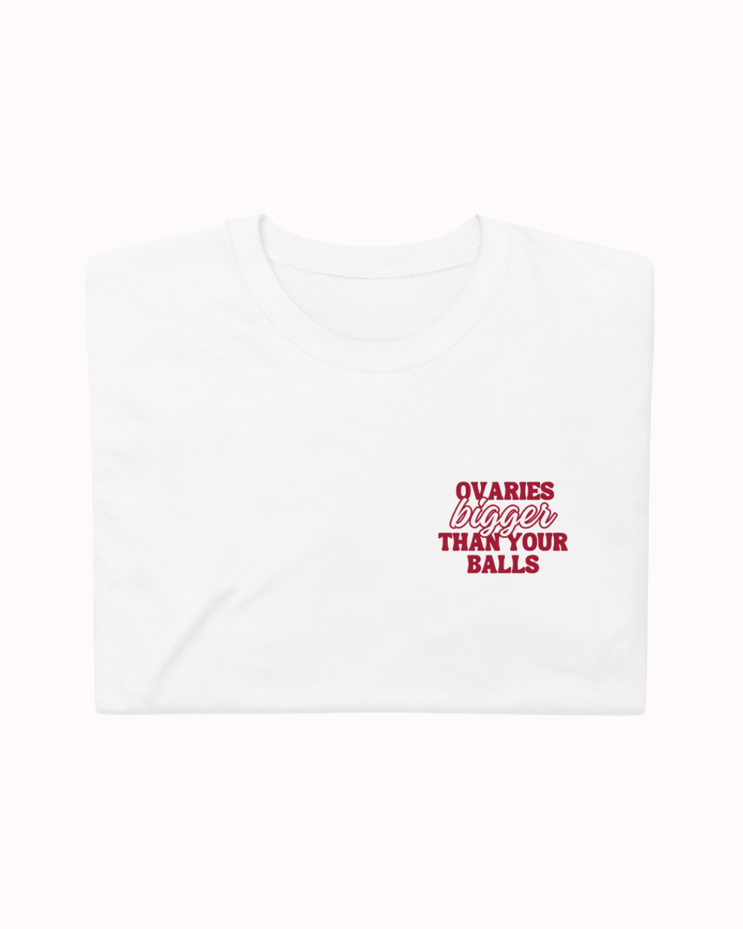 Folded White t-shirt featuring the ironic phrase "Ovaries bigger than your balls". Perfect for fans of funny merchandise, bold humor, and witty sarcasm.