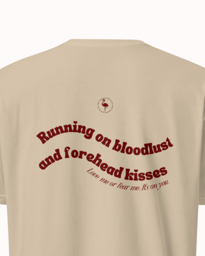 Back view of a Sand t-shirt featuring the phrase "Running on bloodlust and forehead kisses" on the back. Perfect for fans of funny merchandise, bold humor, and witty sarcasm.
