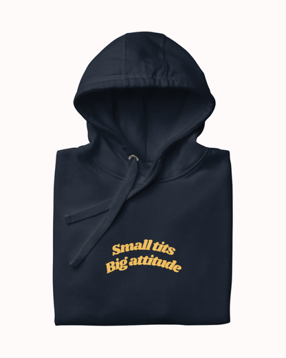Folded Navy Blazer hoodie featuring the ironic phrase "Small tits. Big attitude". Perfect for fans of funny merchandise, bold humor, and witty sarcasm.