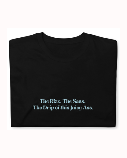 Folded black T-Shirt featuring the ironic phrase 'The rizz. The sass. The drip of this juicy ass'. Perfect for fans of funny merchandise, bold humor, and witty sarcasm. 